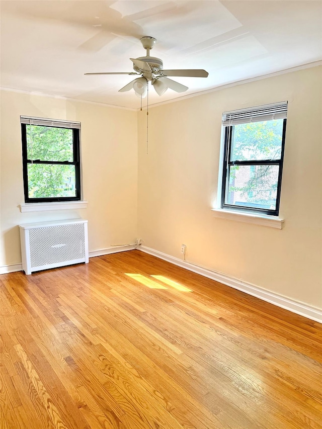 7267 Yellowstone Blvd, Forest Hills, NY 11375 - unfurnished room with radiator, light wood-type flooring, a ceiling fan, and crown molding