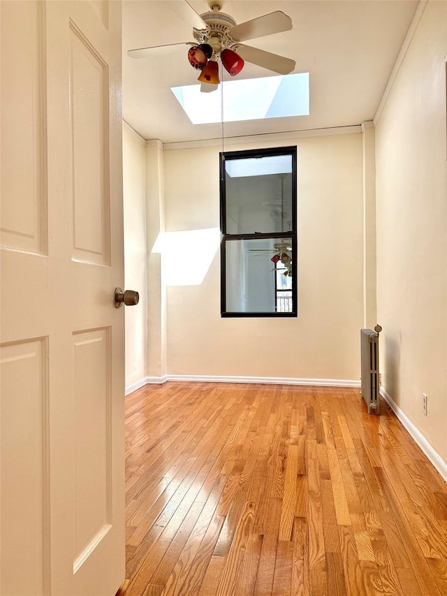 7267 Yellowstone Blvd, Forest Hills, NY 11375 - spare room featuring a skylight, a ceiling fan, wood finished floors, and crown molding
