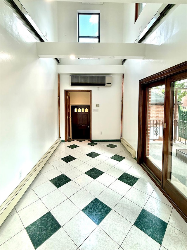 7267 Yellowstone Blvd, Forest Hills, NY 11375 - corridor featuring a towering ceiling, plenty of natural light, light tile patterned flooring, and a baseboard heating unit