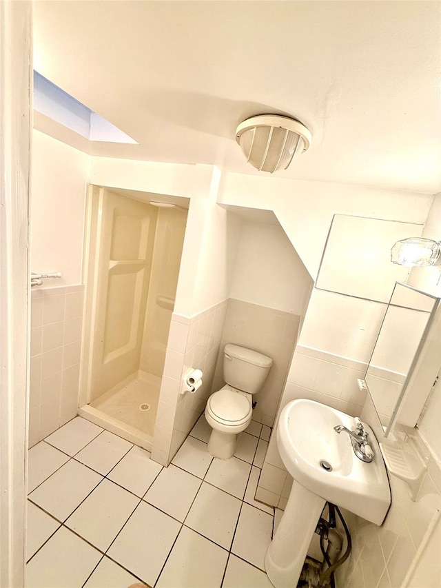 7267 Yellowstone Blvd, Forest Hills, NY 11375 - bathroom with tile walls, a shower stall, tile patterned floors, and wainscoting