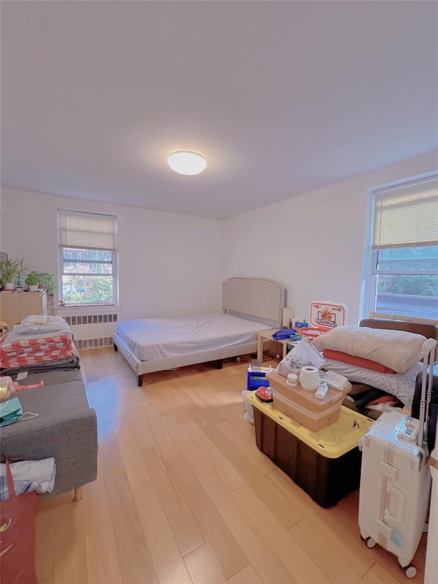 14444 41st Ave Unit 1M, Flushing, NY 11355 - bedroom with light wood-style floors and radiator