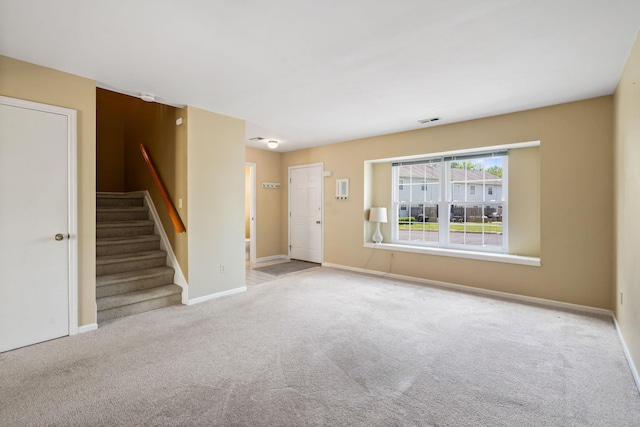 256 Quassaick Ave Unit 17, New Windsor, NY 12553 - unfurnished living room featuring stairway and carpet flooring