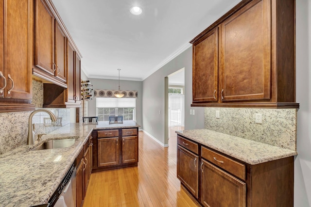 2509 Sylvan Loop, Wappingers Falls, NY 12590 - kitchen with light wood-type flooring, a peninsula, light stone counters, decorative backsplash, and pendant lighting