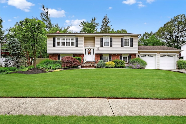 69 Oakland Pl, Nanuet, NY 10954 - split foyer home with a garage, entry steps, a front yard, and brick siding