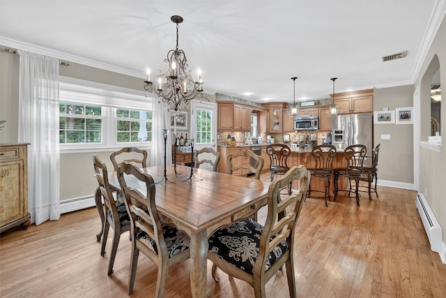 69 Oakland Pl, Nanuet, NY 10954 - dining room featuring a baseboard radiator, a chandelier, light wood-style flooring, and crown molding