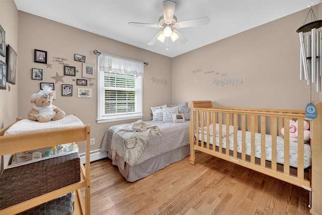 69 Oakland Pl, Nanuet, NY 10954 - bedroom with wood finished floors, a baseboard heating unit, and a ceiling fan