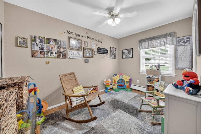 69 Oakland Pl, Nanuet, NY 10954 - recreation room featuring wood finished floors, ceiling fan, and a baseboard heating unit