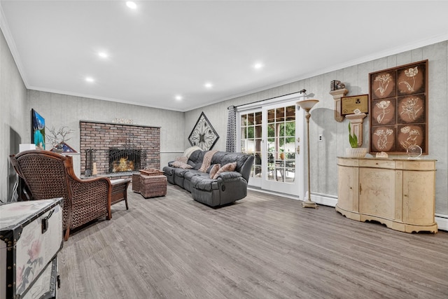 69 Oakland Pl, Nanuet, NY 10954 - living area featuring crown molding, wood finished floors, recessed lighting, a brick fireplace, and baseboard heating