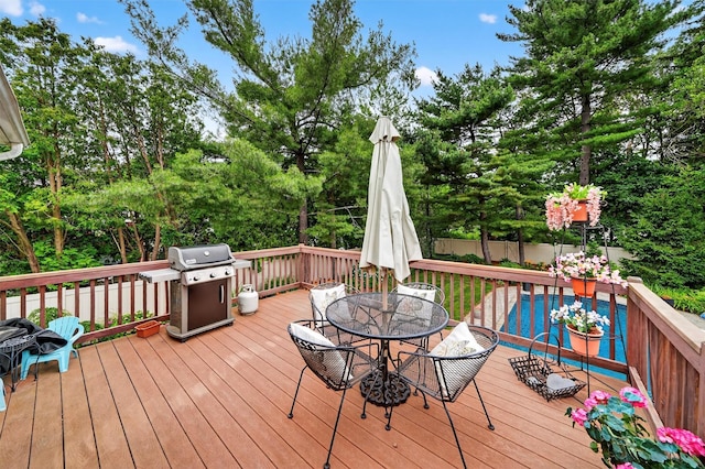 69 Oakland Pl, Nanuet, NY 10954 - deck with a grill, outdoor dining area, and view of scattered trees