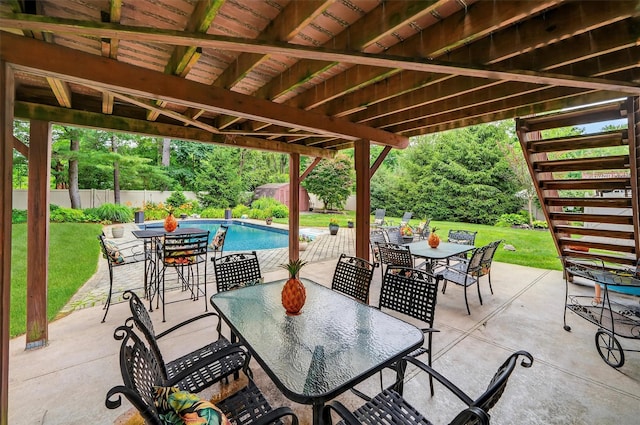 69 Oakland Pl, Nanuet, NY 10954 - fenced backyard featuring outdoor dining area, a patio, stairs, and a storage unit