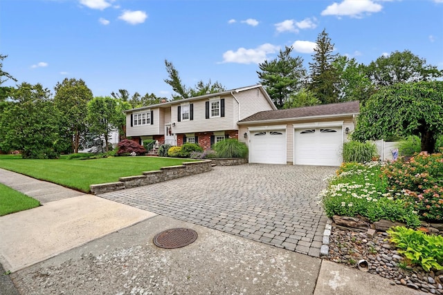69 Oakland Pl, Nanuet, NY 10954 - bi-level home featuring a garage, decorative driveway, a front lawn, and brick siding
