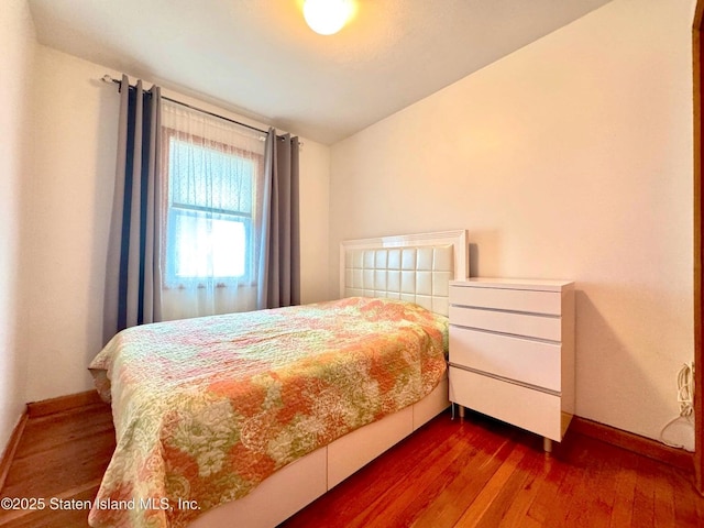 3516 Fillmore Ave, Brooklyn, NY 11234 - bedroom with baseboards and dark wood-type flooring