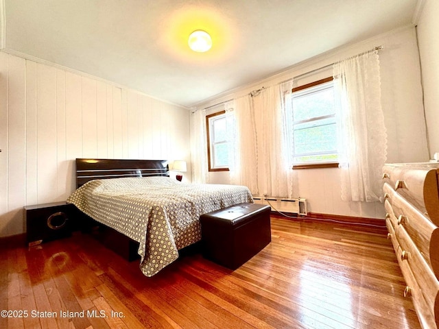 3516 Fillmore Ave, Brooklyn, NY 11234 - bedroom with a baseboard heating unit, hardwood / wood-style flooring, and ornamental molding