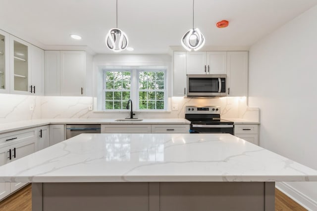 24 Sol Dr, Carmel, NY 10512 - kitchen featuring appliances with stainless steel finishes, white cabinetry, tasteful backsplash, light stone countertops, and recessed lighting