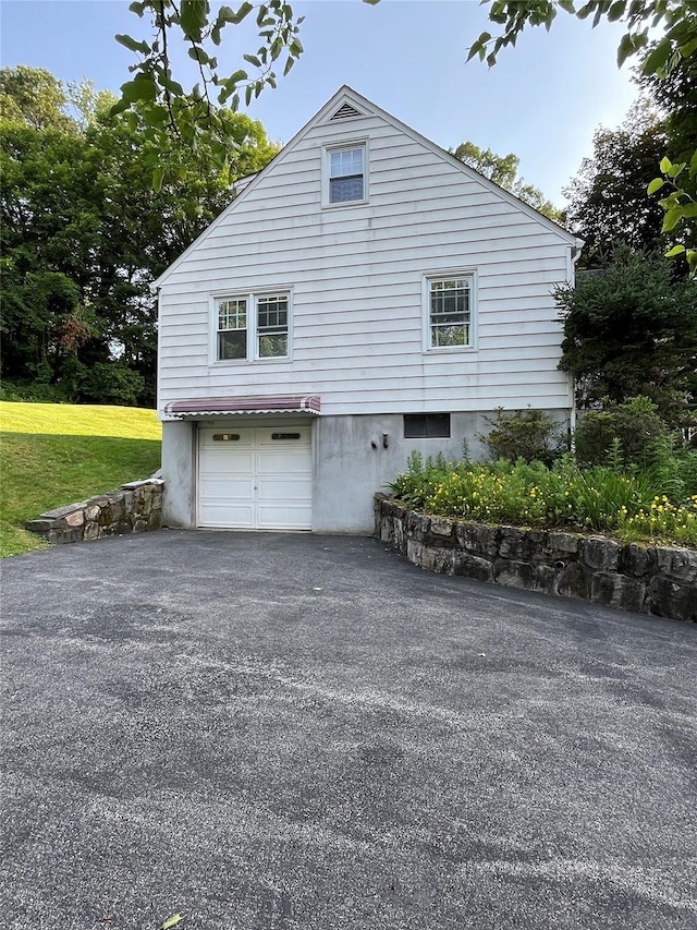 11 Crescent Dr, Cortlandt Manor, NY 10567 - view of home's exterior with a garage, asphalt driveway, and a yard