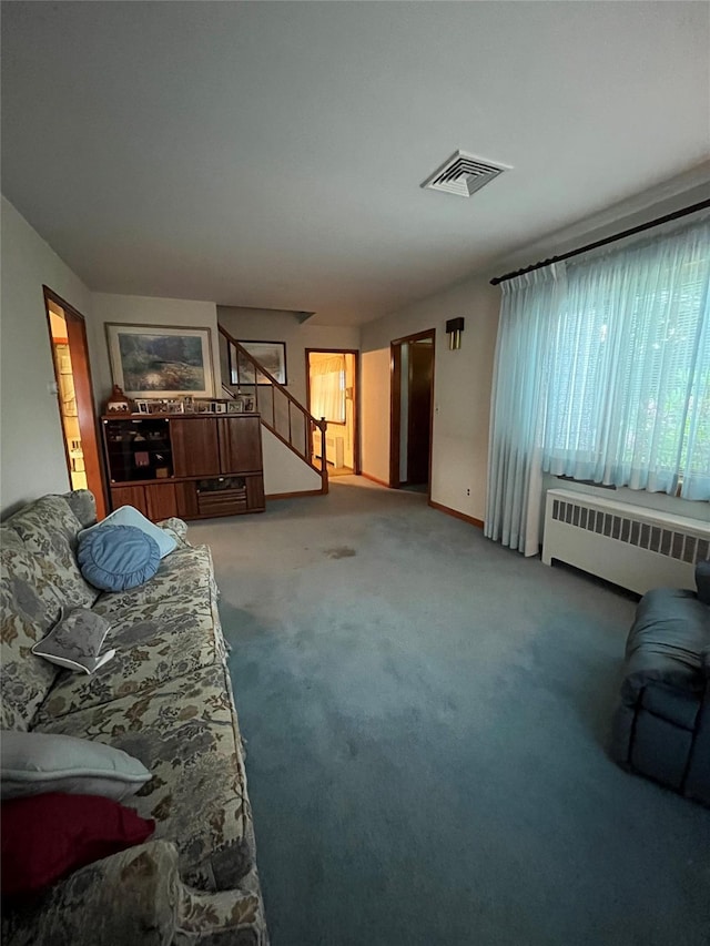 11 Crescent Dr, Cortlandt Manor, NY 10567 - unfurnished living room featuring radiator heating unit, stairway, and carpet flooring
