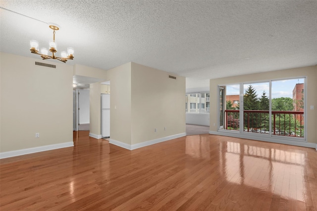 10Stewart Place 3Hw, White Plains, NY 10601 - unfurnished room with a chandelier, a textured ceiling, and light wood-style floors