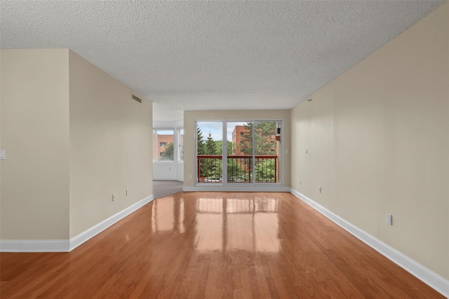 10Stewart Place 3Hw, White Plains, NY 10601 - empty room featuring wood finished floors and a textured ceiling