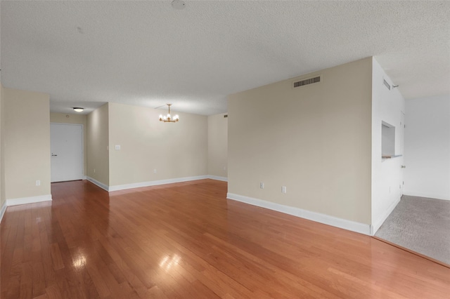 10Stewart Place 3Hw, White Plains, NY 10601 - empty room with a chandelier, wood finished floors, and a textured ceiling