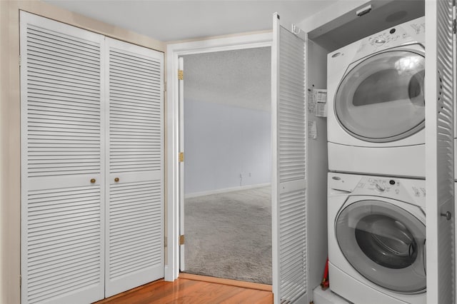 10Stewart Place 3Hw, White Plains, NY 10601 - washroom featuring stacked washer and clothes dryer and wood finished floors