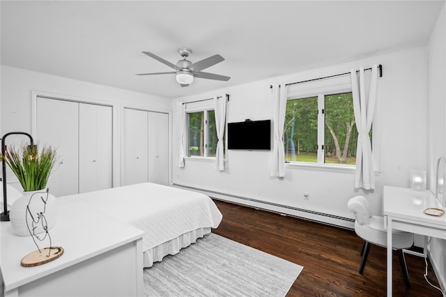 32 Pine Dr, Pound Ridge, NY 10576 - bedroom featuring a baseboard heating unit, two closets, wood finished floors, and ceiling fan