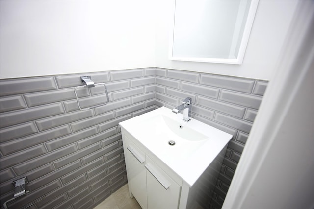 59 Stratford Grn Unit 59, Farmingdale, NY 11735 - bathroom featuring vanity, tile walls, and wainscoting