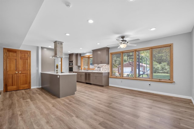 49 Oakridge Rd, North Salem, NY 10560 - kitchen with island exhaust hood, stainless steel appliances, a peninsula, light countertops, and a ceiling fan