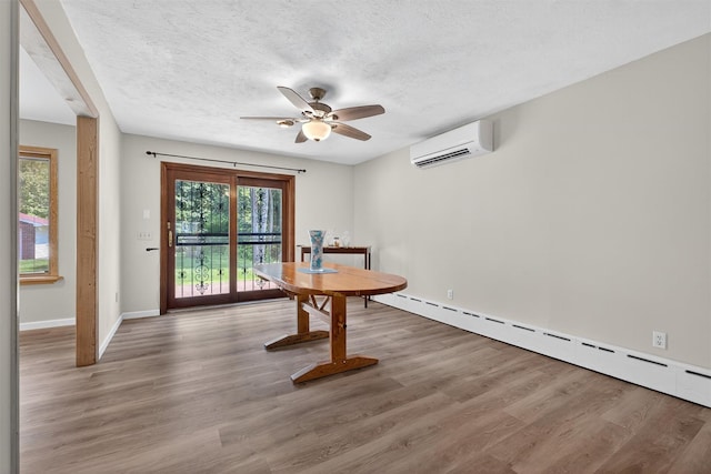 49 Oakridge Rd, North Salem, NY 10560 - unfurnished dining area featuring a wall mounted AC, a baseboard heating unit, ceiling fan, wood finished floors, and a textured ceiling