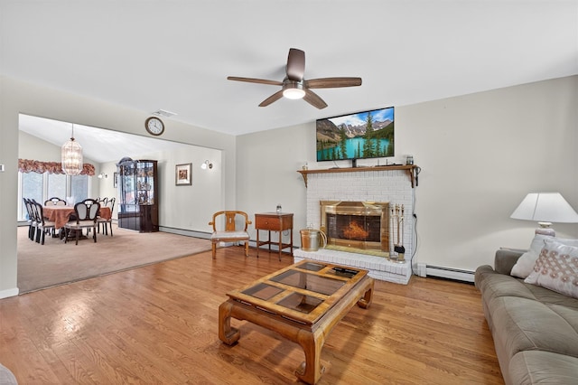 49 Oakridge Rd, North Salem, NY 10560 - living area featuring a baseboard radiator, a ceiling fan, wood finished floors, a brick fireplace, and lofted ceiling
