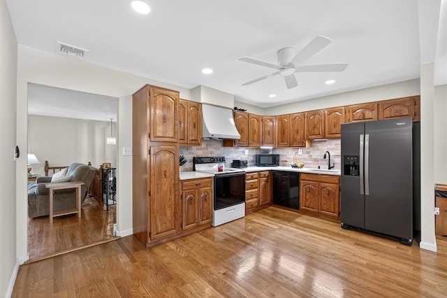 49 Oakridge Rd, North Salem, NY 10560 - kitchen featuring black appliances, custom exhaust hood, a ceiling fan, brown cabinets, and light countertops