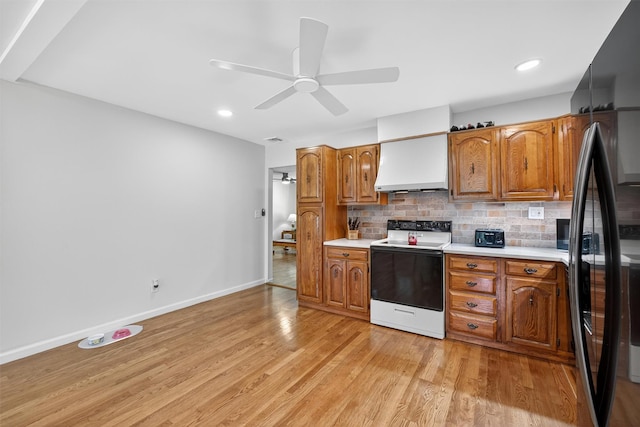 49 Oakridge Rd, North Salem, NY 10560 - kitchen featuring white range with electric stovetop, premium range hood, freestanding refrigerator, light countertops, and recessed lighting
