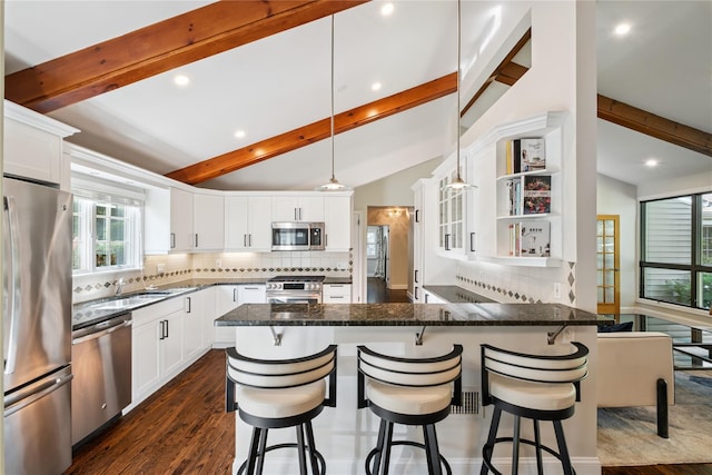 96 Highridge Rd, New Rochelle, NY 10804 - kitchen featuring appliances with stainless steel finishes, a peninsula, recessed lighting, backsplash, and dark wood finished floors