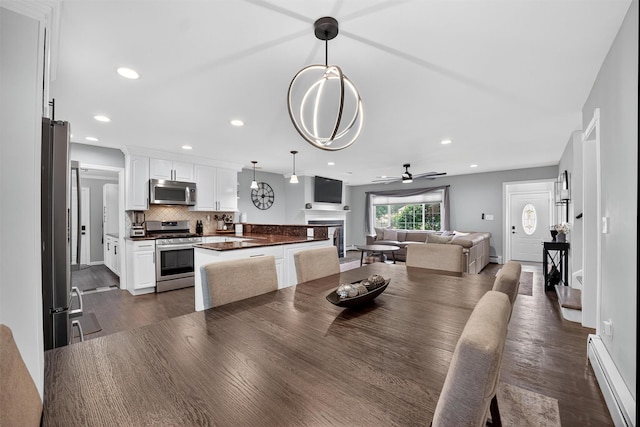 6 Spring Rock Rd, New Windsor, NY 12553 - dining room with a baseboard heating unit, dark wood-type flooring, a ceiling fan, and recessed lighting