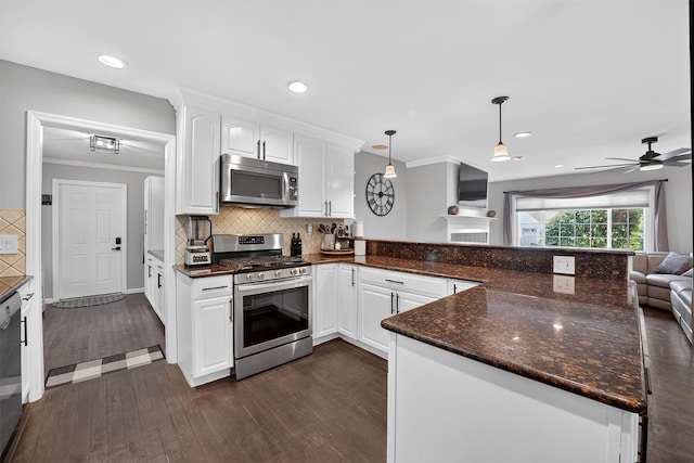 6 Spring Rock Rd, New Windsor, NY 12553 - kitchen featuring appliances with stainless steel finishes, a peninsula, open floor plan, dark wood-type flooring, and white cabinetry