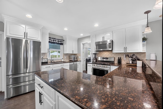 6 Spring Rock Rd, New Windsor, NY 12553 - kitchen with appliances with stainless steel finishes, white cabinets, tasteful backsplash, dark wood-style floors, and a peninsula