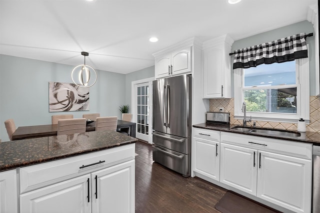 6 Spring Rock Rd, New Windsor, NY 12553 - kitchen with appliances with stainless steel finishes, decorative backsplash, dark wood-type flooring, white cabinets, and dark stone countertops