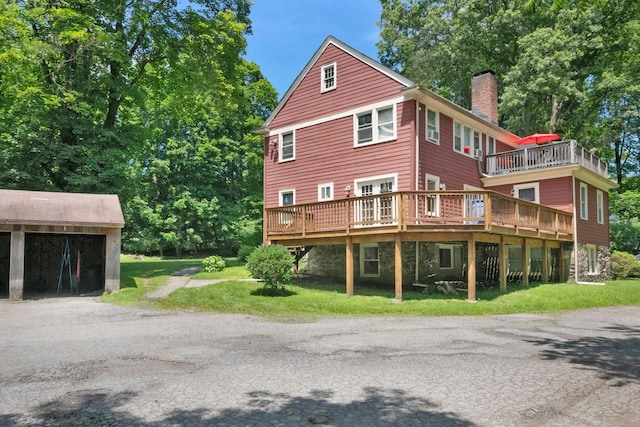 858 Pleasantville Rd, Briarcliff Manor, NY 10510 - rear view of house featuring a chimney, a wooden deck, and a yard