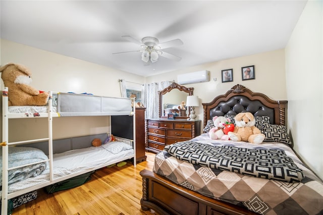 81-56 264th St, Glen Oaks, NY 11004 - bedroom with a wall unit AC, wood finished floors, and a ceiling fan