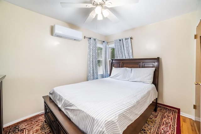 81-56 264th St, Glen Oaks, NY 11004 - bedroom with a wall unit AC, light wood-style floors, and ceiling fan