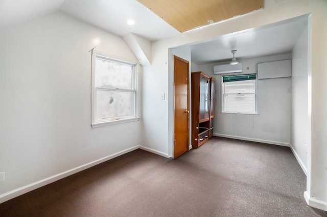81-56 264th St, Glen Oaks, NY 11004 - unfurnished bedroom featuring multiple windows, a wall mounted air conditioner, and lofted ceiling