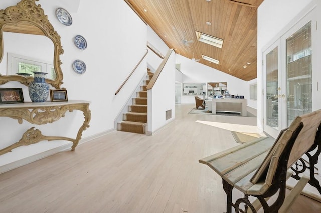 61 Hidden Cove Ct, Southampton, NY 11968 - stairs with wooden ceiling, wood finished floors, a skylight, and high vaulted ceiling