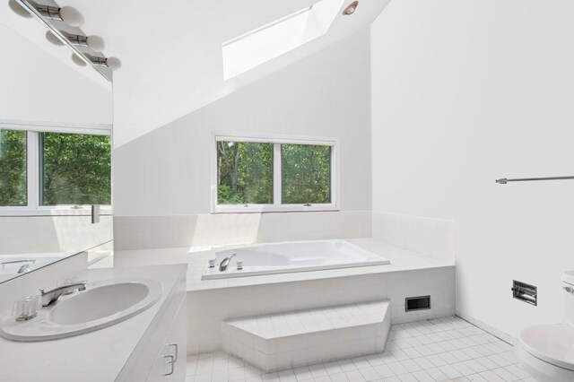 61 Hidden Cove Ct, Southampton, NY 11968 - full bath with a skylight, a garden tub, vanity, and tile patterned flooring