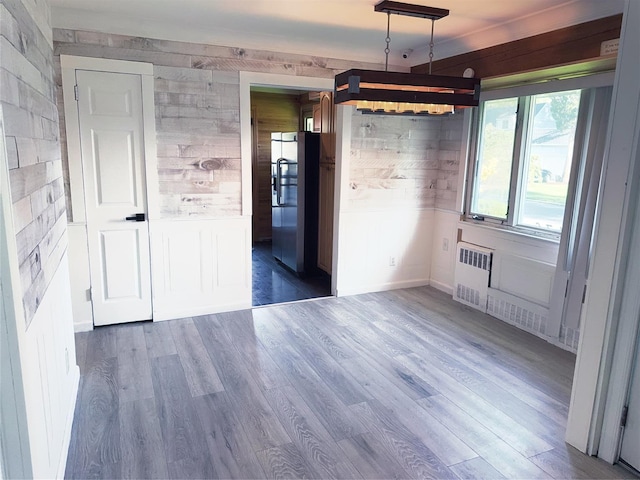 176 Floyd St, Brentwood, NY 11717 - unfurnished dining area with wood finished floors and radiator