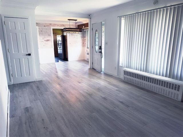 176 Floyd St, Brentwood, NY 11717 - unfurnished room with radiator heating unit, crown molding, and wood finished floors