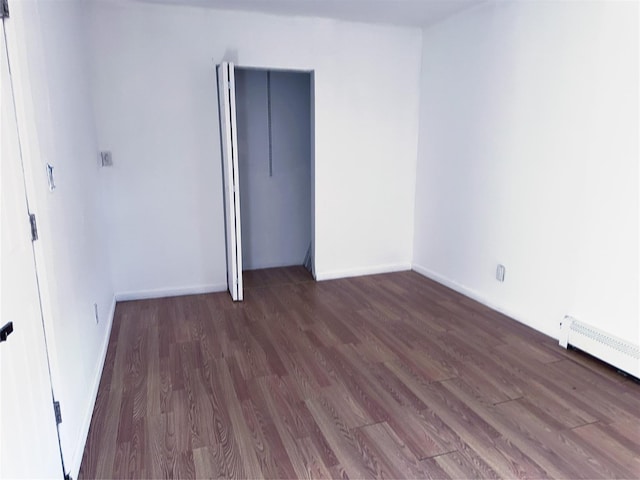 176 Floyd St, Brentwood, NY 11717 - unfurnished room with wood finished floors and baseboard heating