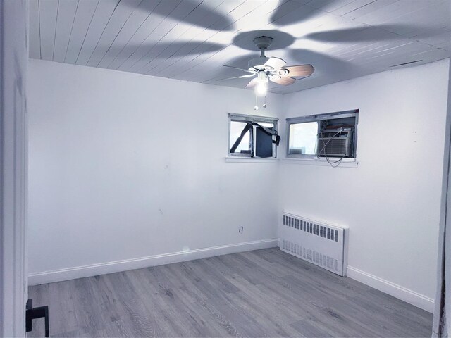 176 Floyd St, Brentwood, NY 11717 - spare room featuring radiator, ceiling fan, and wood finished floors