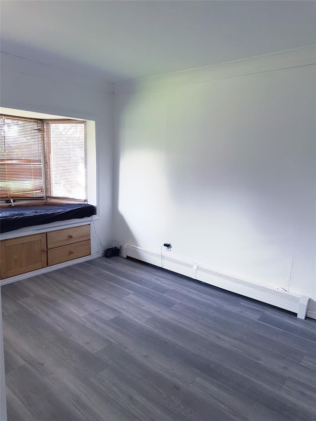 176 Floyd St, Brentwood, NY 11717 - empty room featuring baseboard heating and dark wood finished floors