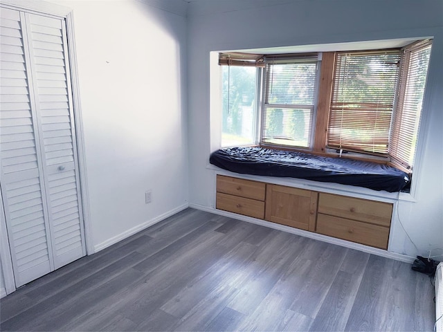 176 Floyd St, Brentwood, NY 11717 - unfurnished bedroom with dark wood finished floors and baseboards