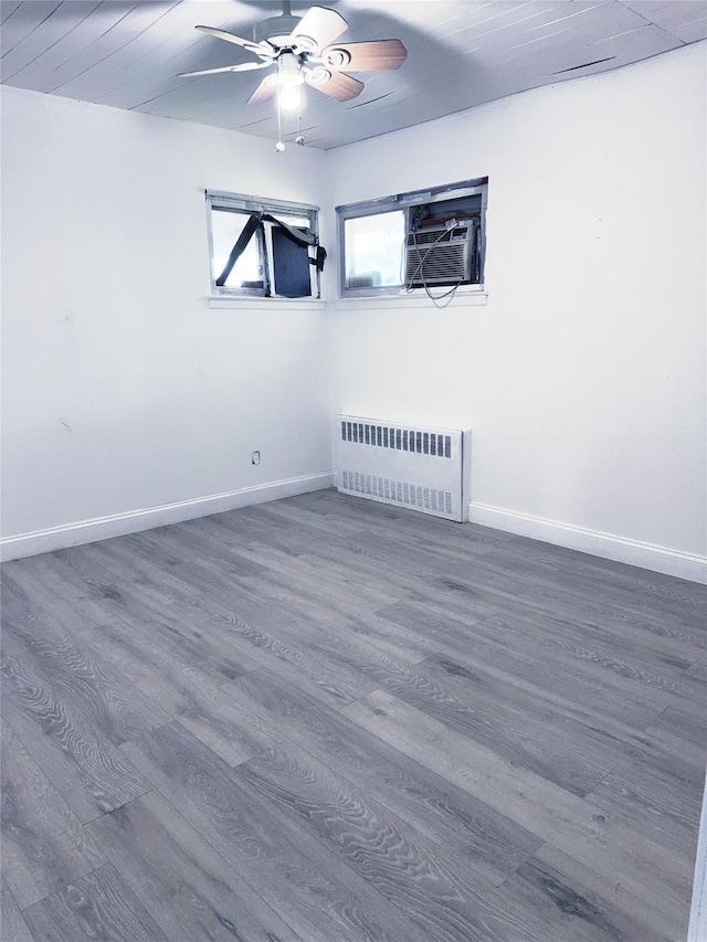 176 Floyd St, Brentwood, NY 11717 - empty room featuring radiator heating unit, ceiling fan, and wood finished floors