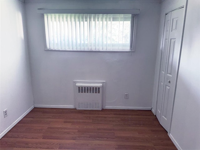 176 Floyd St, Brentwood, NY 11717 - unfurnished bedroom featuring a closet, wood finished floors, and radiator